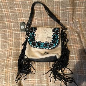 Teal and hair on hide with hand leather tooling